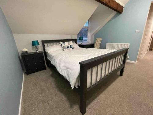 una camera da letto con un letto grande con lenzuola e cuscini bianchi di Sundial Cottage, Stunning 3 Bed Cottage with Hottub a Skelton