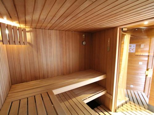 a wooden sauna with a bench in the middle at Splendid villa in Flemish Ardennes with pool in Zottegem