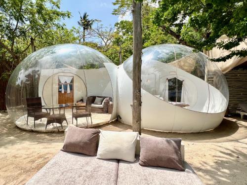 two glass domes with a couch in front of it at Rock and Sea Resort in Watamu