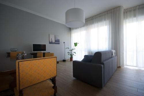 a living room with a couch and a chair at Appartamento - Rho Centro 4 - in Rho