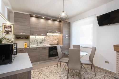 a kitchen with a table and chairs and a tv at La Casa dei Nonni in Isola del Gran Sasso dʼItalia