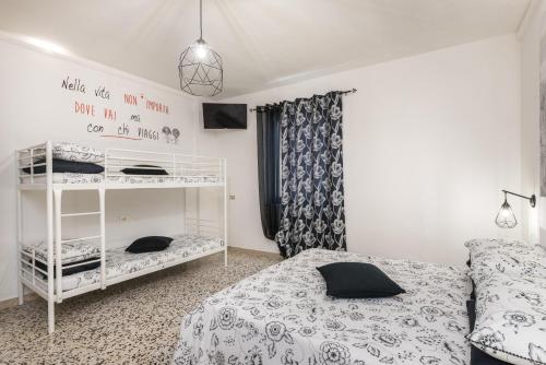 a bedroom with a bed and a bunk bed at La Casa dei Nonni in Isola del Gran Sasso dʼItalia