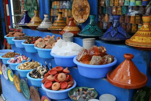 a display of different types of ceramics on a shelf at Appartement Panoramique in Casablanca