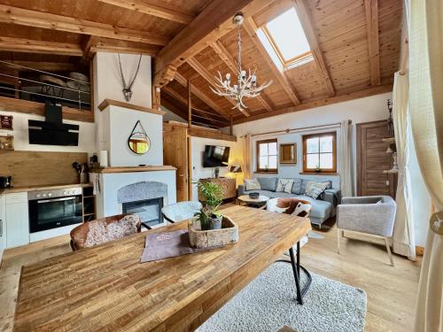 a living room with a wooden table and a couch at CHALET BELLE KITZ by Belle Stay in Kitzbühel