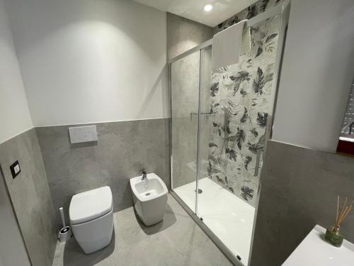 a bathroom with a toilet and a shower and a sink at Nonna Mina B&B in Rapagnano