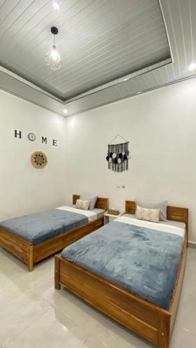 Ένα ή περισσότερα κρεβάτια σε δωμάτιο στο Juliana HomeStay