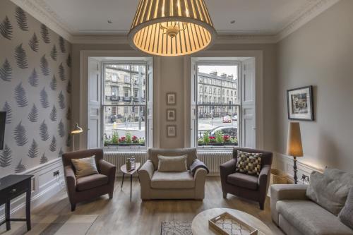 a living room filled with furniture and a large window at Haymarket Apartments in Edinburgh