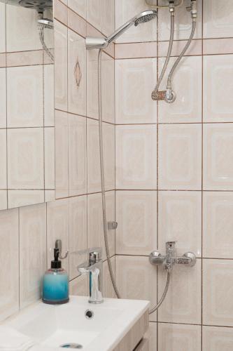 a bathroom with a shower and a white sink at Starfish Complex in Porto Rafti