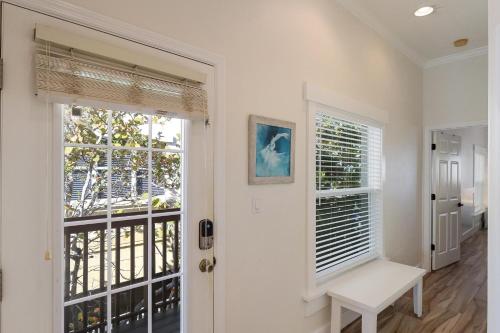 a white door with a bench next to a window at Sunset Sands at Capri in Bradenton Beach