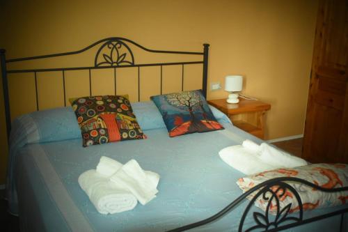 a bed with towels and pillows in a bedroom at Marsilio B&B in Abatemarco