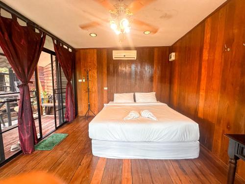 a bedroom with a bed with two towels on it at Nakra Hill Mae on in Ban On Luai