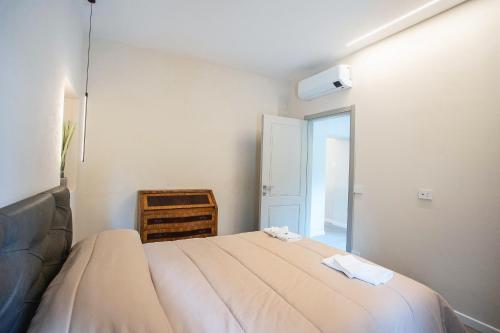 a bedroom with a bed with two towels on it at Villa Giuliana in Arezzo