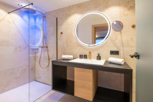 a bathroom with a sink and a mirror at Hotel B&B VILLA-ALPIN in Grossarl