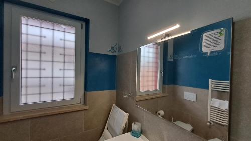 a bathroom with a toilet and a sink and a mirror at Guest House Roma Express in Ladispoli