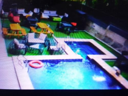 a view of a swimming pool with chairs and a frisbee at Villa toscana luxe hotel and suites in Port Harcourt