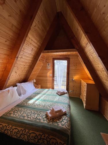 a bedroom with a bed in an attic at Chalet Natura Sport&Relax in Cavaliere