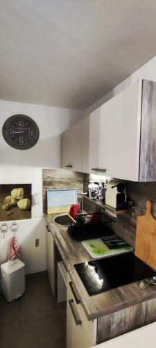 une cuisine avec des armoires blanches et un comptoir dans l'établissement Studio Cabine La Grande Motte, à La Grande Motte