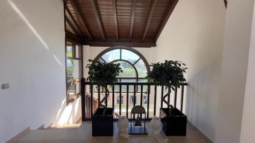 a hallway with two potted plants and a window at Villa La Vista - FAMILY FRIENDLY Private Pool, BBQ, Sauna in Benalmádena
