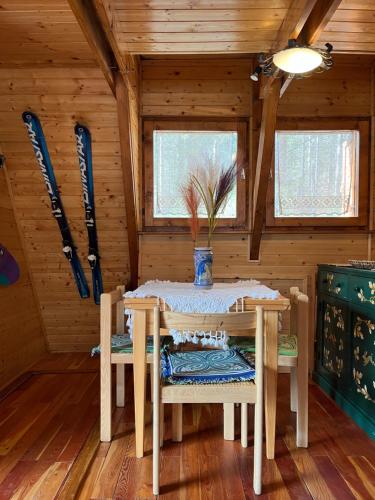 a dining room with a table and chairs in a cabin at Chalet Natura Sport&Relax in Cavaliere
