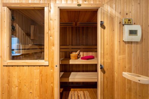 a room with a sauna with a wooden wall at Villa Pugna - Private Pool, BBQ, Sauna in Benalmádena