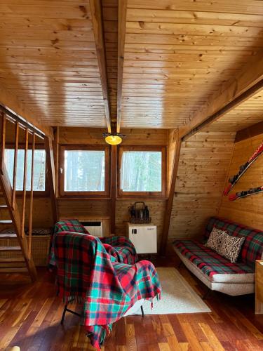 a room with two chairs and a couch in a cabin at Chalet Natura Sport&Relax in Cavaliere