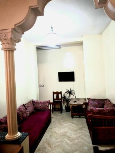 a living room with two couches and a tv at Appartement à Meknès in Meknès