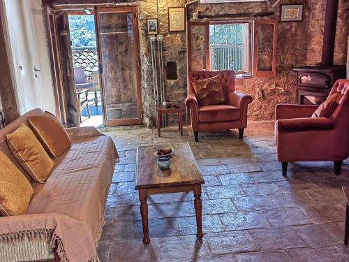 a living room with a couch and chairs and a table at PITHARIA in Askas