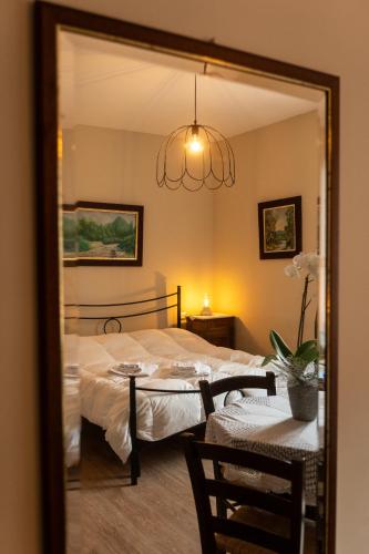 a bedroom with a bed and a table and a mirror at Masseria boutique b&b in Montella