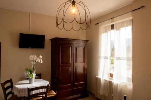 a dining room with a table and a chandelier at Masseria boutique b&b in Montella