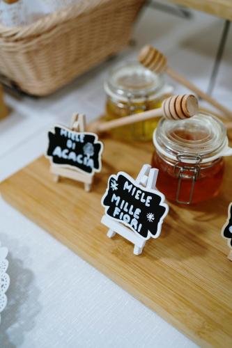 a wooden cutting board with a mason jar of honey at Hotel Premiere in Marina di Varcaturo
