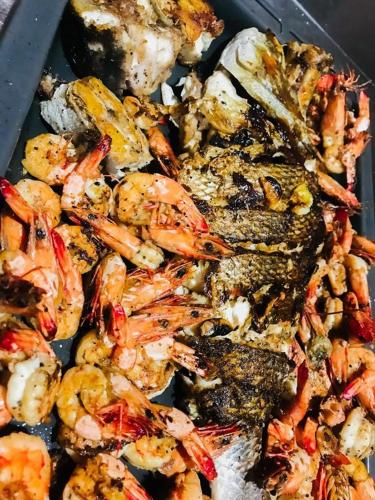 a tray filled with shrimp and other food items at The Tottam Beach Hotel - Trincomalee in Trincomalee