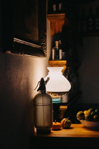 a small figurine sitting on top of a lamp on a table at Statek Poštolka in Svitavy