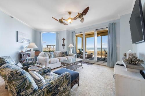 a living room with a couch and a tv at Beach Colony West 1B in Perdido Key