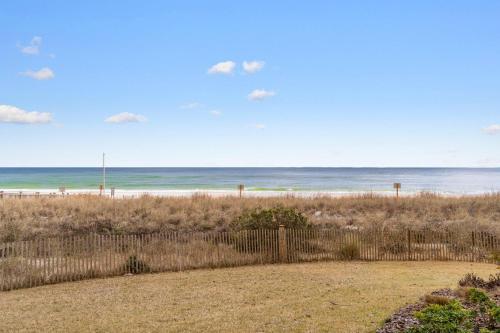 a view of the beach from behind a fence at Beach Colony West 1B in Perdido Key