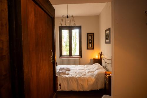 a bedroom with a bed and a window at Masseria boutique b&b in Montella