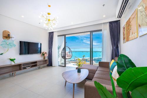 a living room with a couch and a tv at Homestay The Sóng căn hộ nghỉ dưỡng tốt nhất năm 2024 in Vung Tau