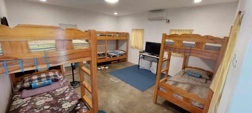 an overhead view of a room with three bunk beds at Beach House, San Juan, La Union in San Juan