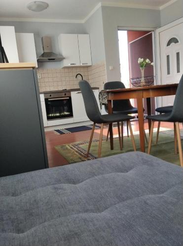 a kitchen and dining room with a table and chairs at Kuća za odmor Mirni kutak Vukovar in Vukovar
