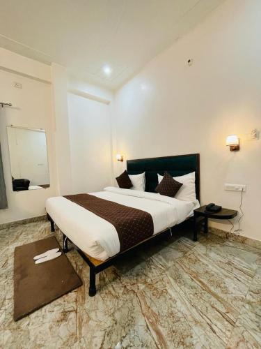 a bedroom with a large bed in a room at Hotel Sangam View in Prayagraj