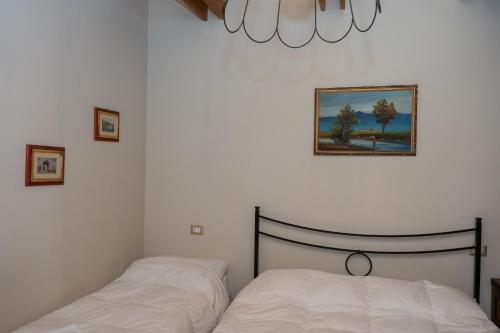 a bedroom with a bed and a picture on the wall at Masseria boutique b&b in Montella
