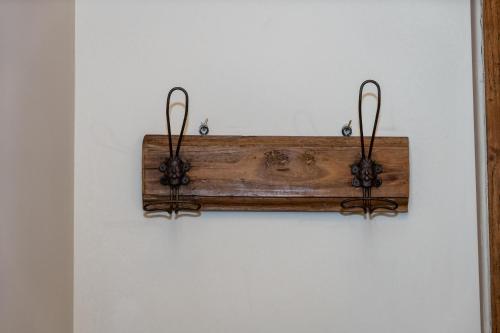 a wooden item hanging on a white wall at Masseria boutique b&b in Montella