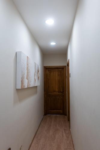 a hallway with a door and a painting on a wall at Masseria boutique b&b in Montella