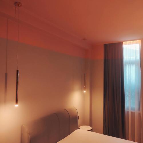 a bedroom with a bed and a window at L Suites The Writer's House in Gythio