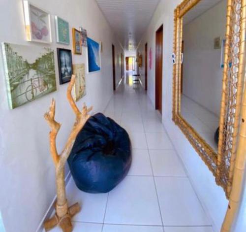 a hallway with a blue bean bag chair and a mirror at La Pousada in Maceió