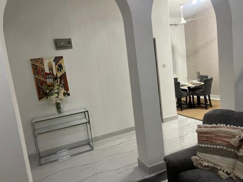 a living room with a vase of flowers on a table at Nashu House Stone Town in Ngambo
