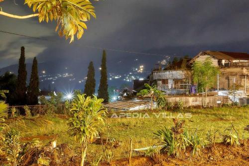 a view of a city at night with buildings and trees at Villa DBusso Apedia, 3 BR, SP, Billiard, Karaoke in Kopo 2