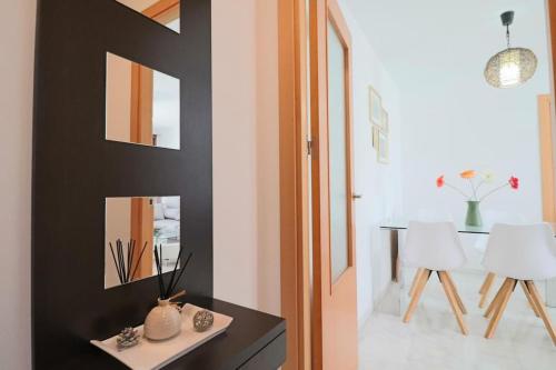 a room with a table and two white chairs at Apartamento Junto al campo de golf in El Portil