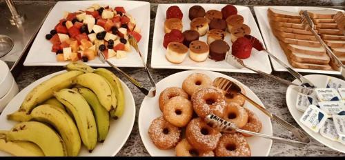three plates of different types of food on a table at Le MIAMI RESORT in Puducherry