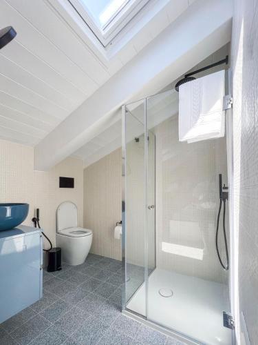a bathroom with a glass shower and a toilet at Lara Maison in Acciaroli