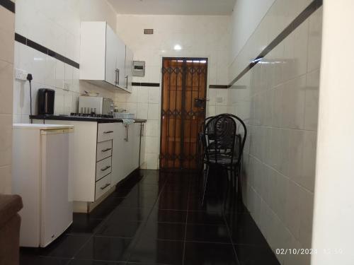 a kitchen with a door and a chair in it at PaTerrace guest lodge in Harare